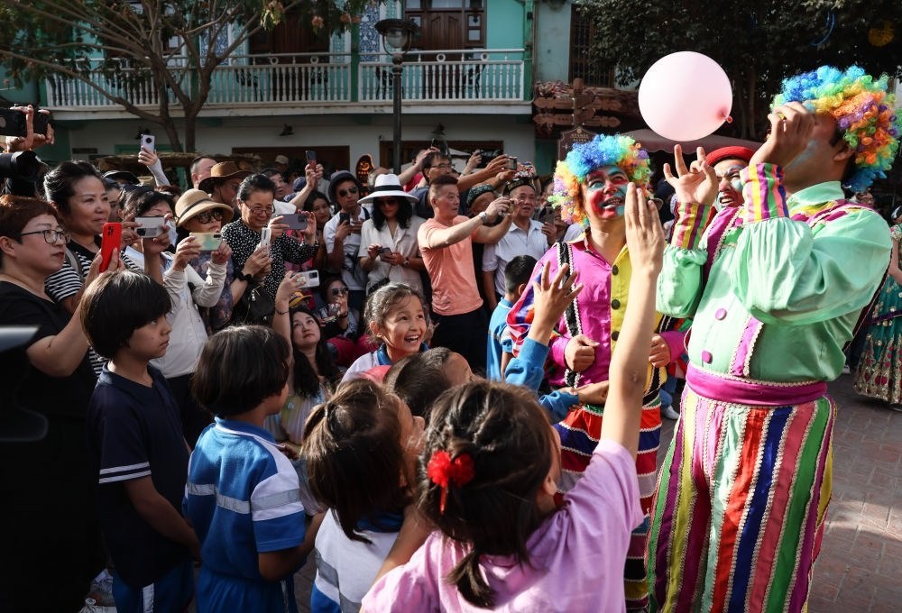 演員與小朋友在新疆喀什古城景區(qū)互動（2023年9月7日攝）。新華社記者 蘭紅光 攝