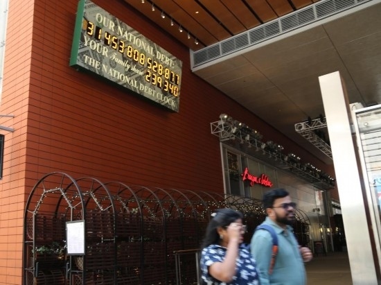 2023年5月29日，人們經(jīng)過(guò)美國(guó)紐約曼哈頓的“國(guó)債鐘”?！皣?guó)債鐘”是一個(gè)大型計(jì)數(shù)器，它實(shí)時(shí)更新美國(guó)的公共債務(wù)總額，并顯示出每個(gè)美國(guó)家庭所要負(fù)擔(dān)的數(shù)額。 新華社記者劉亞南攝