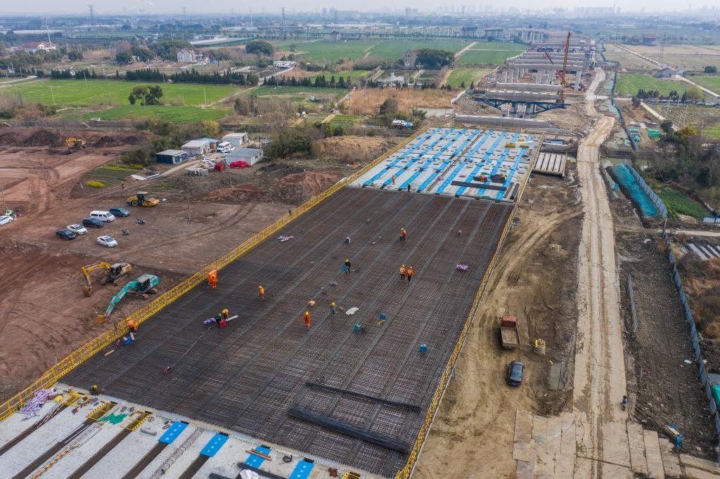 3月7日，在524國(guó)道秀洲王江涇至新塍公路工程TJ02標(biāo)段，作業(yè)人員正在進(jìn)行60米鋼混組合梁現(xiàn)澆橋面板鋼筋焊接及綁扎作業(yè)（無人機(jī)照片）。新華社記者 徐昱 攝