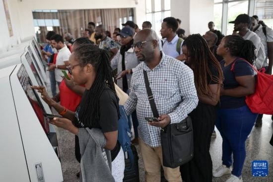 5月31日，在蒙內(nèi)鐵路內(nèi)羅畢站，乘客在自助取票機前排隊取票。新華社記者 楊光 攝